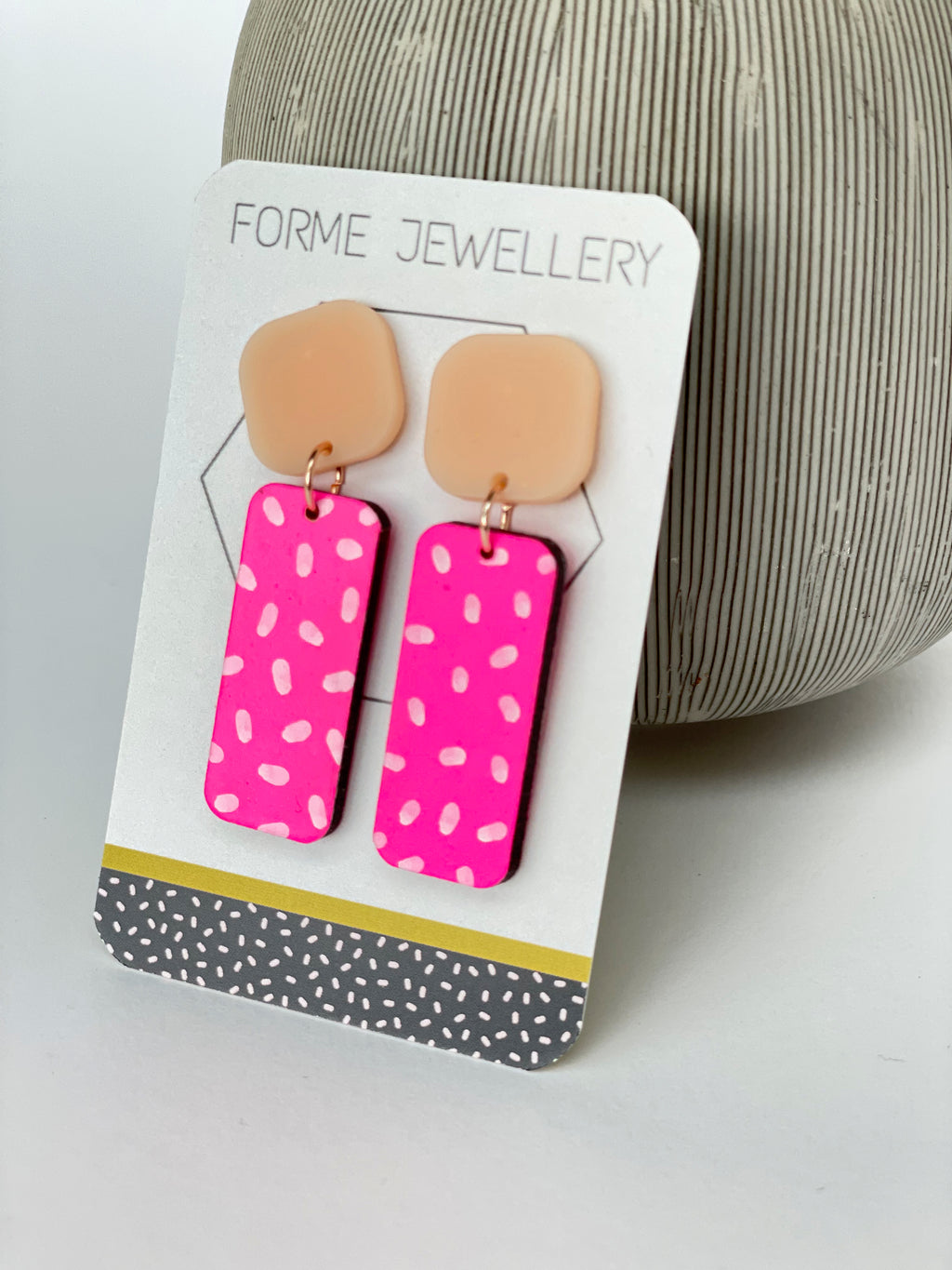 NEON PINK DANGLY RECTANGULAR EARRINGS WITH A WHITE DASH PATTERN