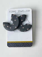 Load image into Gallery viewer, Dark grey geometric earrings on a 'Forme Jewellery' card with a white background
