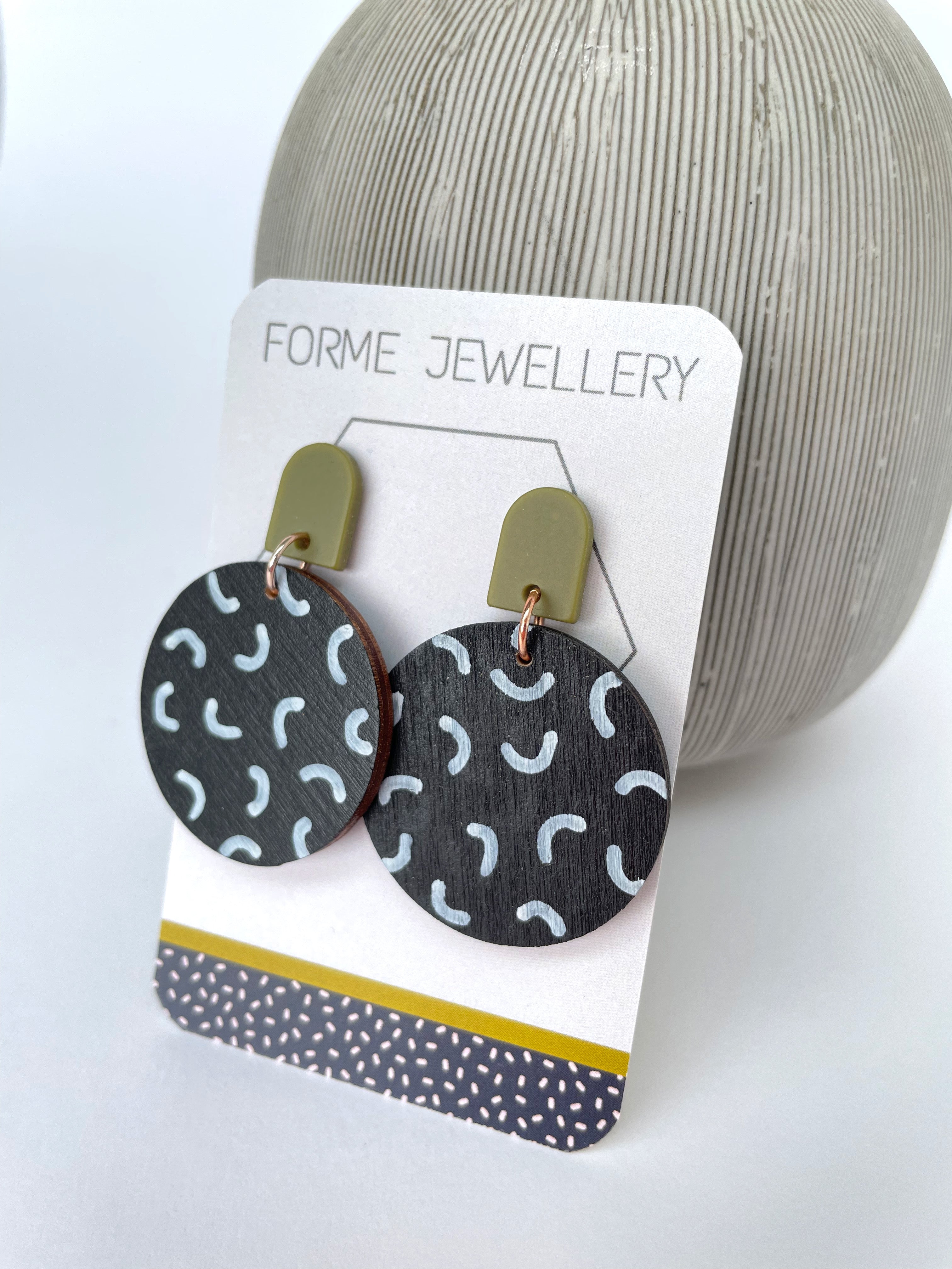 Circular Black Dangly Earrings with a white pattern